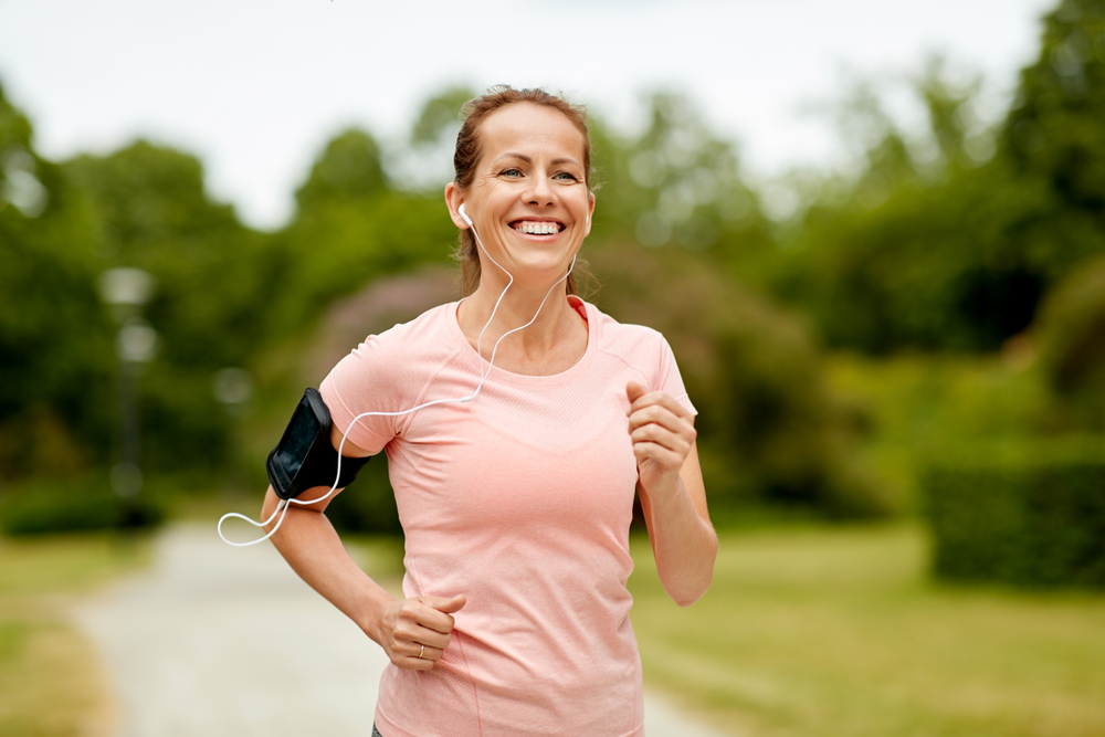 Woman enjoys jogging outdoors after removing her breast implants.
